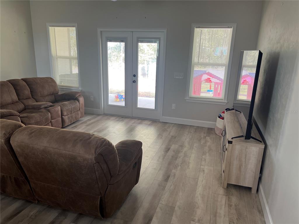 7746 Southeast 70th Avenue Trenton, FL 32693 - Photo 4 of 13 a living room with furniture and a flat screen tv