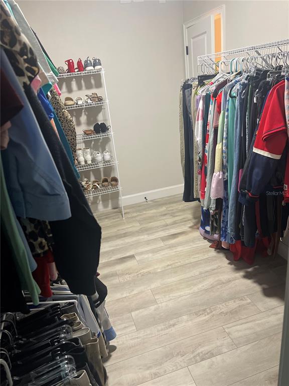 7746 Southeast 70th Avenue Trenton, FL 32693 - Photo 8 of 13 a view of walk in closet with clothes and shoes