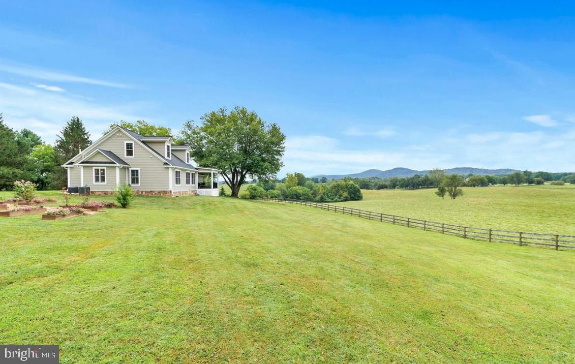 9520 Maidstone Road Delaplane, VA 20144 - Photo 3 of 3 a view of a white house with a yard and lake view