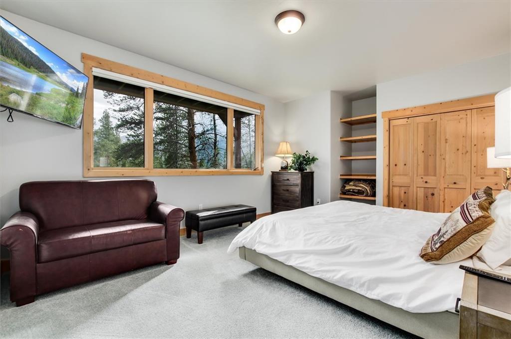 15 Rounds Road Breckenridge, CO 80424 - Photo 29 of 34 a bedroom with a bed couch and a large window