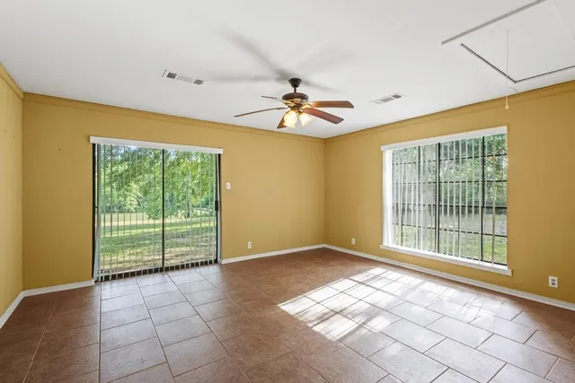 a view of a bathroom with double vanity and a window