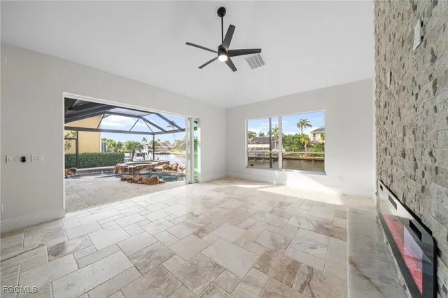 a view of a livingroom with a floor to ceiling window and wooden floor