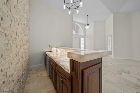 a bathroom with a granite countertop sink a mirror and vanity