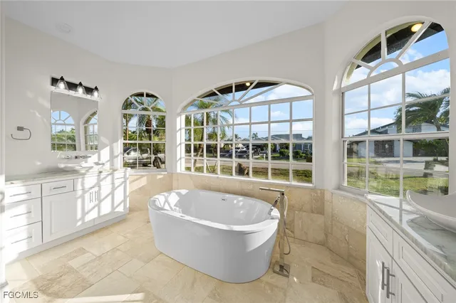 a spacious bathroom with a tub and large windows