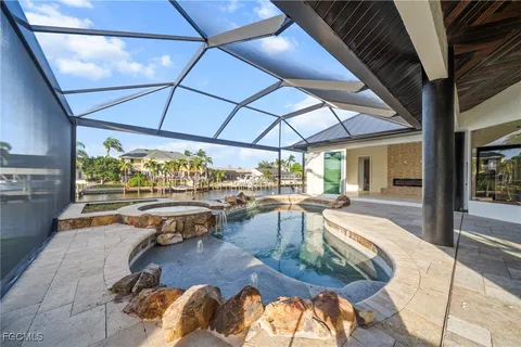 a view of a swimming pool with outdoor seating