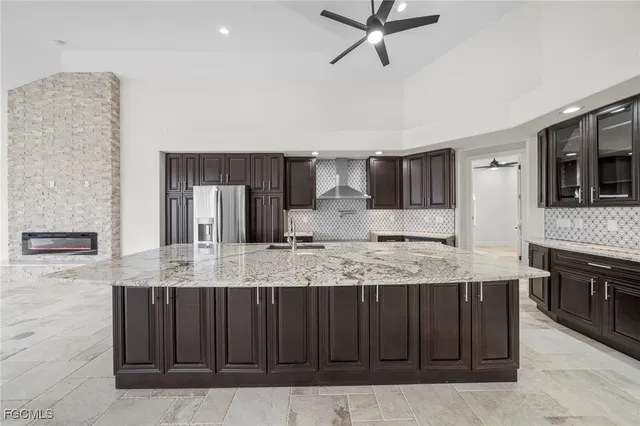 a large kitchen with kitchen island granite countertop a sink and a stove