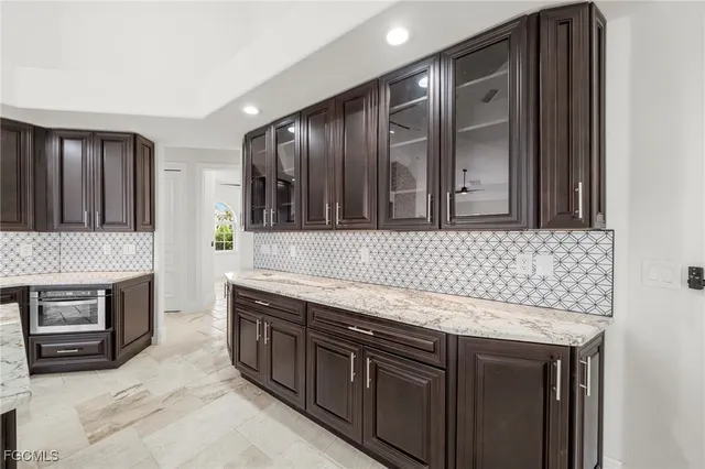 a kitchen with stainless steel appliances granite countertop a sink stove and oven