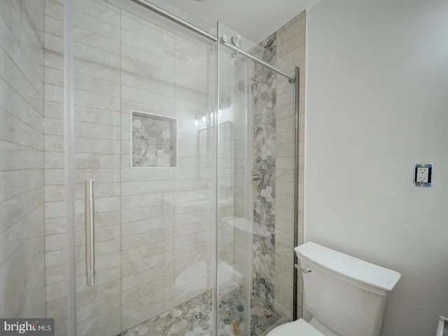a bathroom with a shower and a toilet