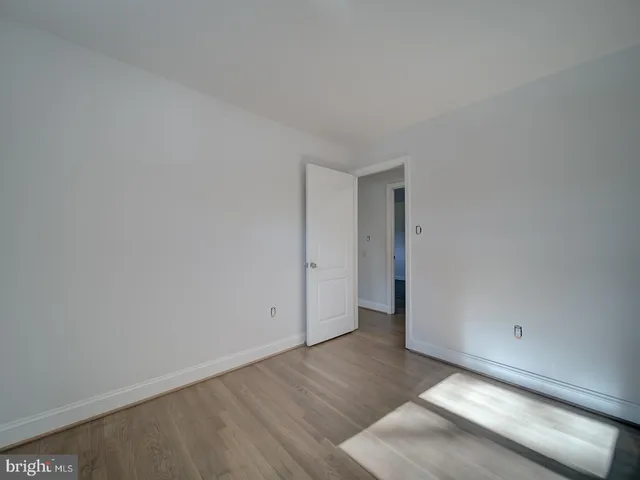 a view of an empty room and wooden floor