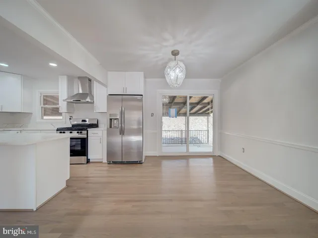 a kitchen with granite countertop a stove top oven a sink and cabinets