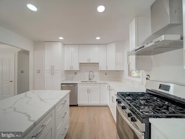 a kitchen with a stove a sink and a refrigerator