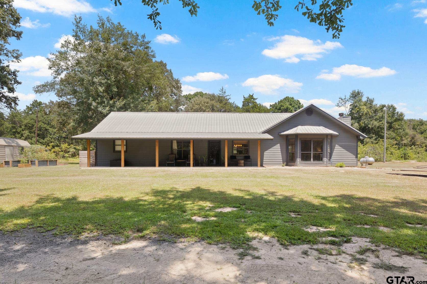259 County Road 2407 Pittsburg, TX 75686 - Photo 1 of 42 a front view of a house with a garden