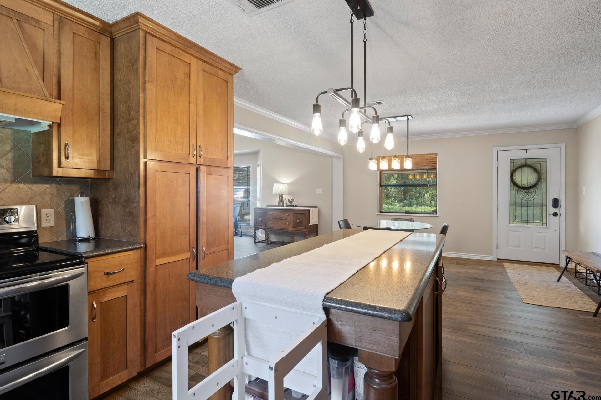 259 County Road 2407 Pittsburg, TX 75686 - Photo 11 of 42 a kitchen with sink and refrigerator