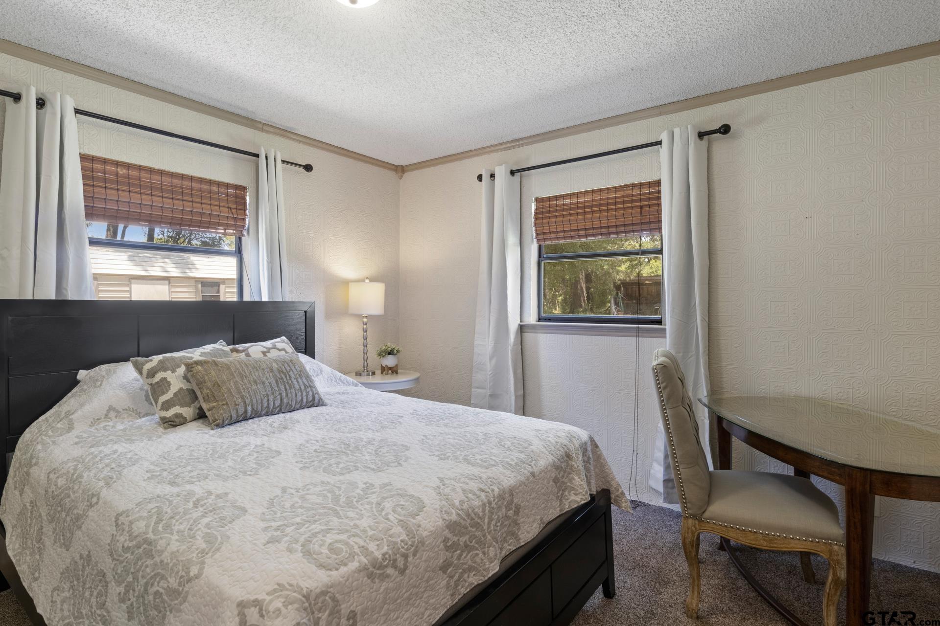259 County Road 2407 Pittsburg, TX 75686 - Photo 12 of 42 a bedroom with a bed and a window