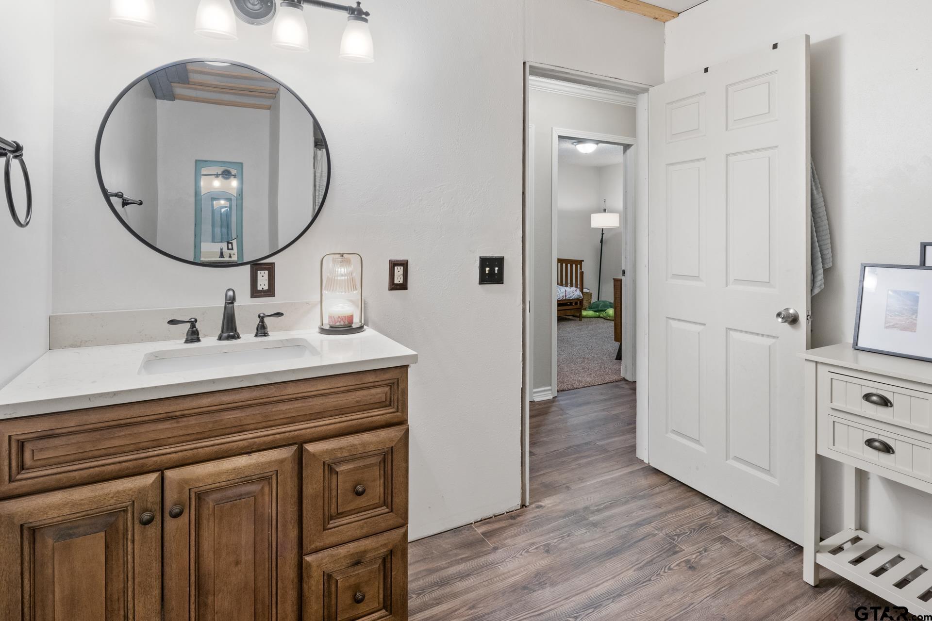 259 County Road 2407 Pittsburg, TX 75686 - Photo 15 of 42 a bathroom with a sink and a mirror