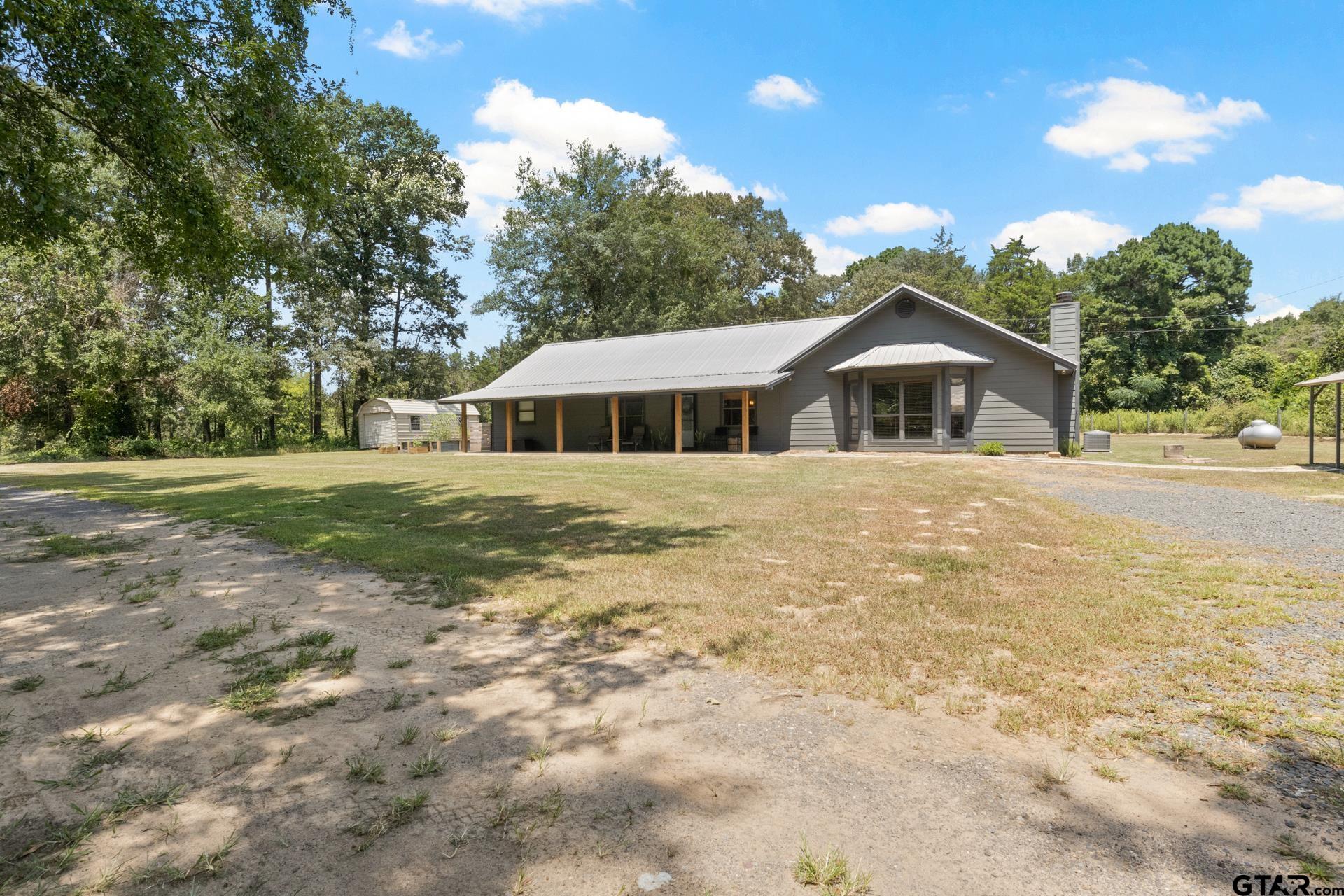 259 County Road 2407 Pittsburg, TX 75686 - Photo 2 of 42 a front view of a house with a yard