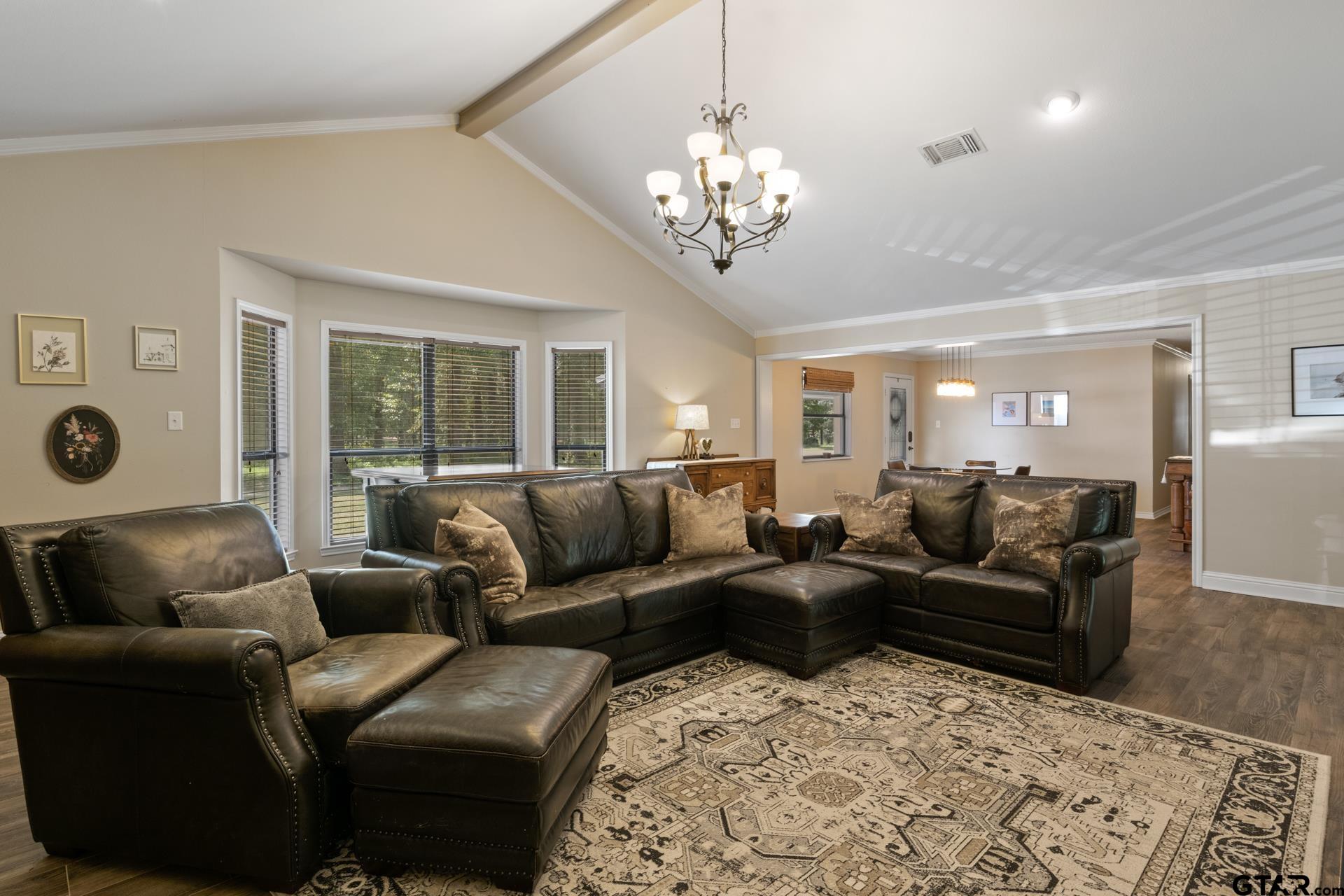 259 County Road 2407 Pittsburg, TX 75686 - Photo 23 of 42 a living room with furniture and a chandelier