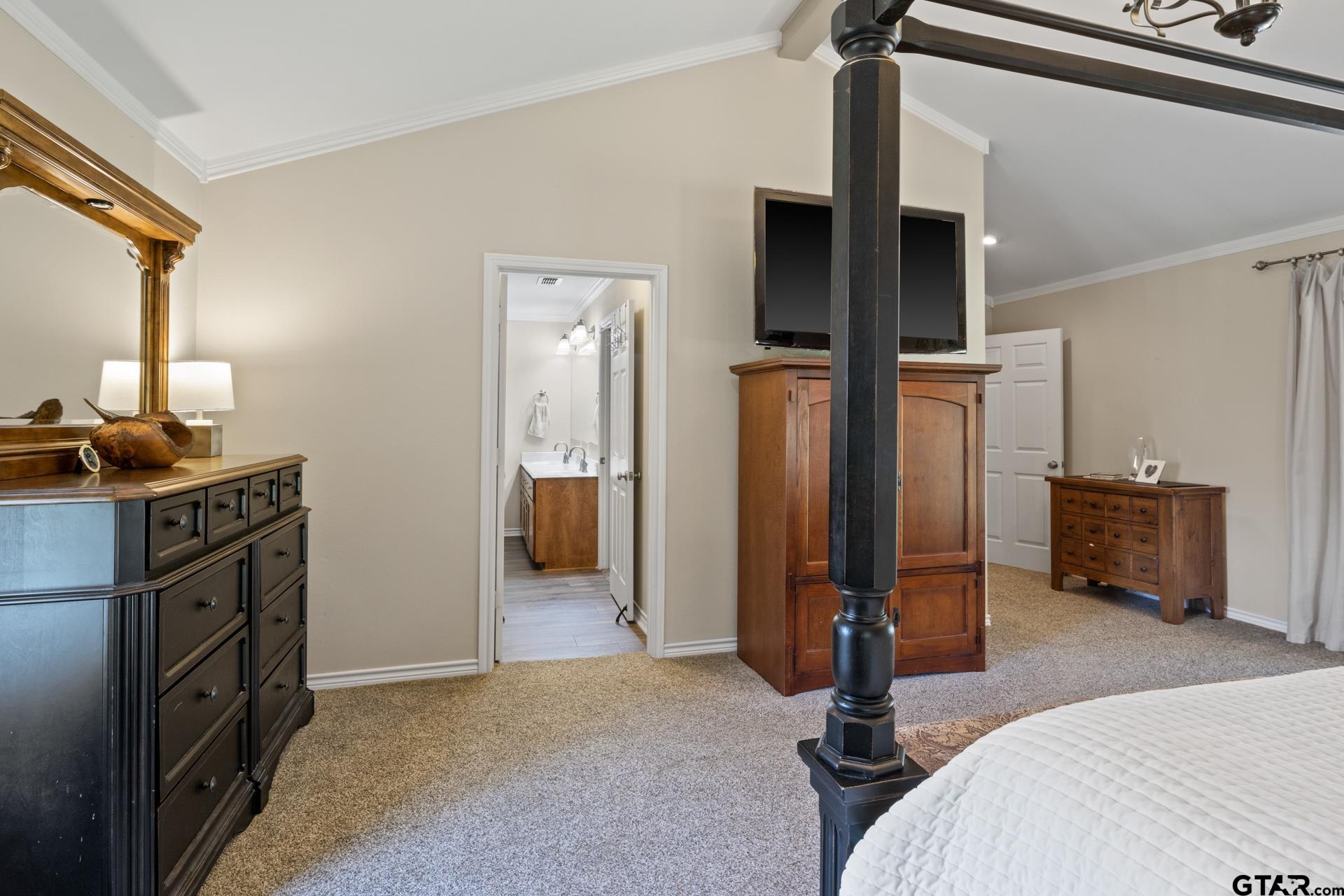 259 County Road 2407 Pittsburg, TX 75686 - Photo 29 of 42 a bedroom with a bed and a tv on the dresser