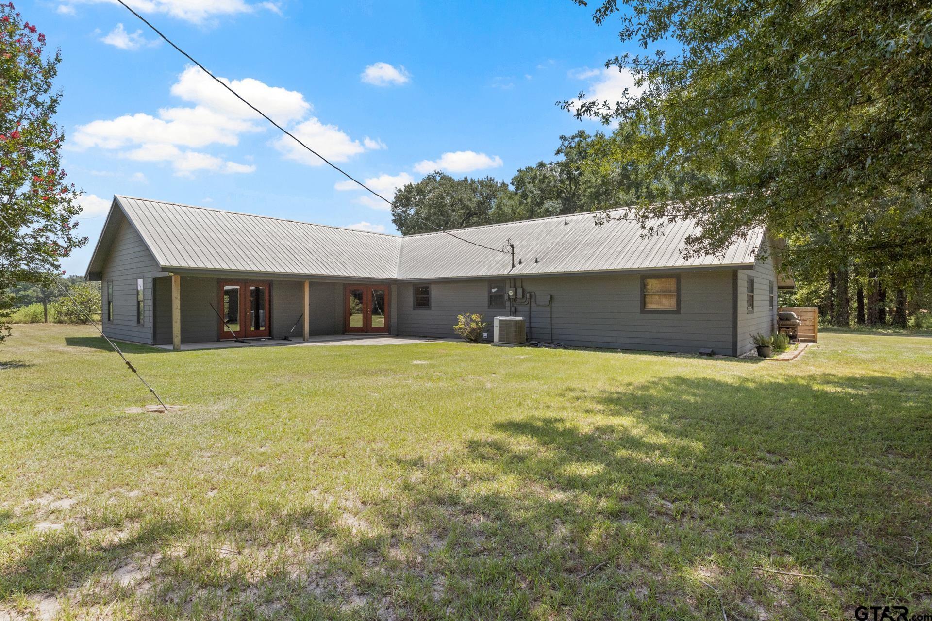 259 County Road 2407 Pittsburg, TX 75686 - Photo 35 of 42 a front view of a house with a yard and garage