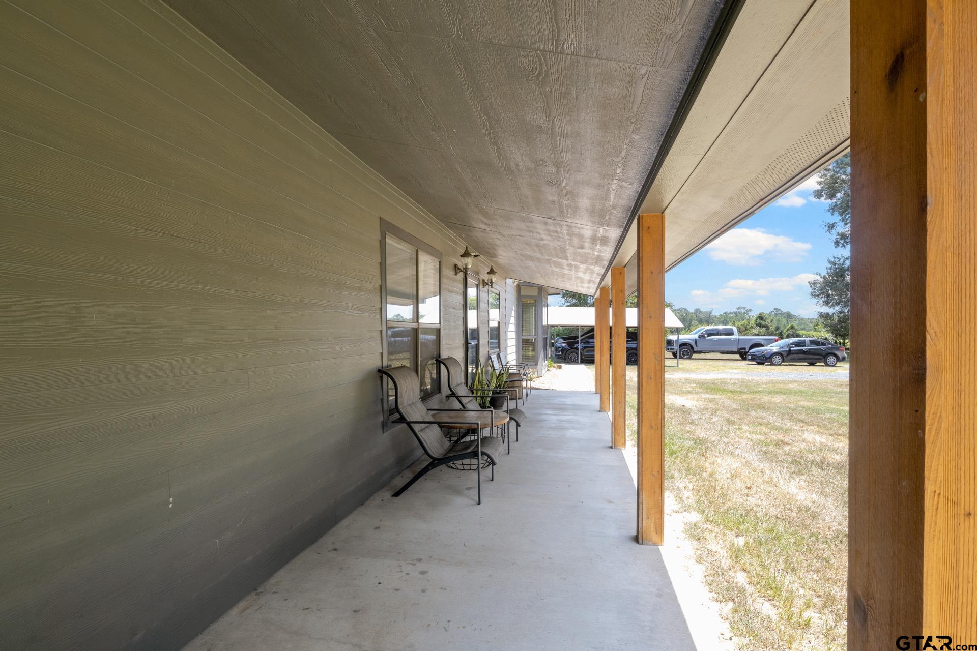 259 County Road 2407 Pittsburg, TX 75686 - Photo 4 of 42 a view of an empty room and floor to ceiling windows