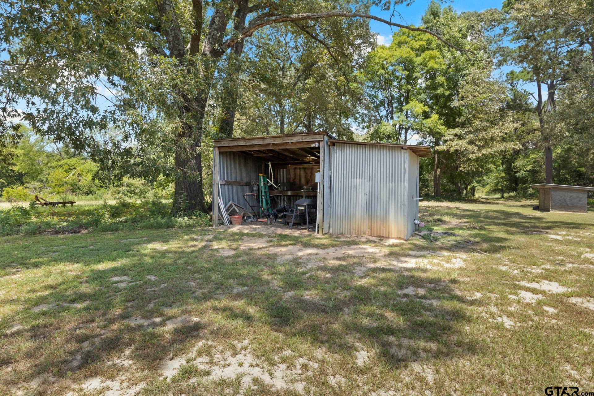 259 County Road 2407 Pittsburg, TX 75686 - Photo 42 of 42 a view of a house with backyard and tree