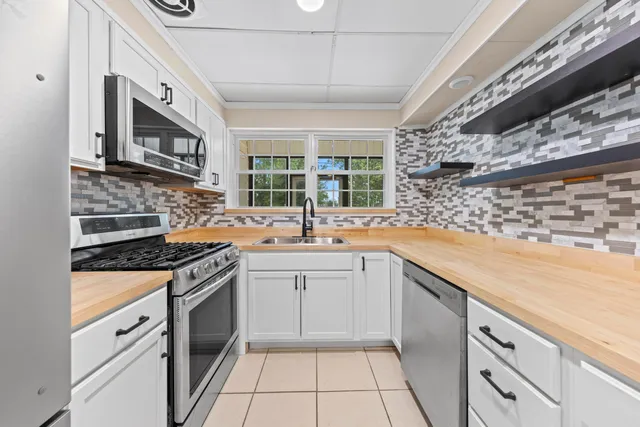 a kitchen with stainless steel appliances granite countertop a stove and a sink