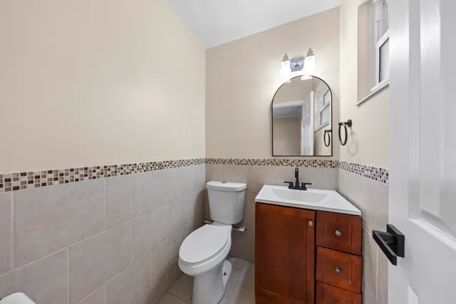 a bathroom with a toilet sink and mirror