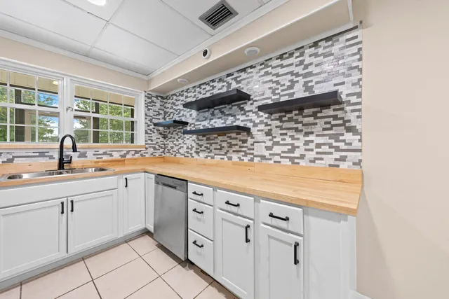 a kitchen with cabinets and window