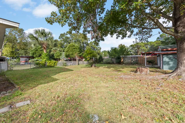 a backyard of a house with table and chairs