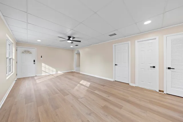 a view of an empty room with wooden floor