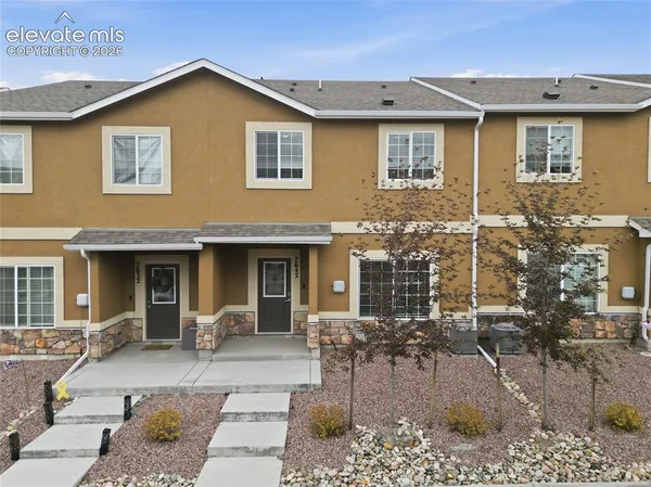 a front view of a house with outdoor seating