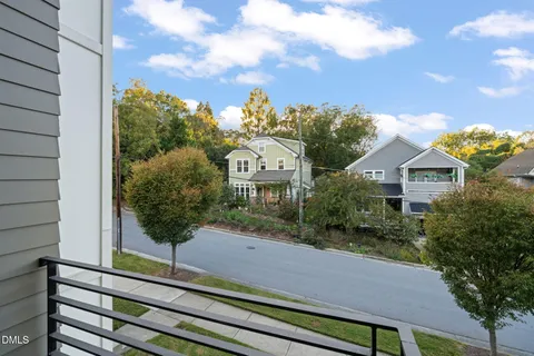 a front view of a house with a yard and balcony