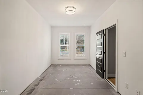 an empty room with a empty space and windows