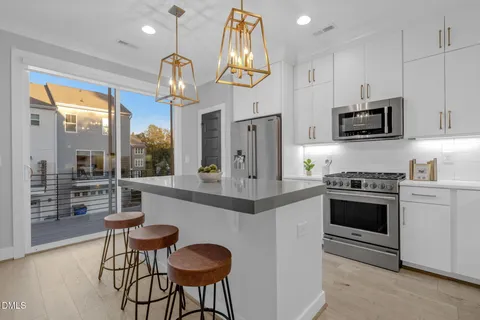 a kitchen with cabinets and chandelier