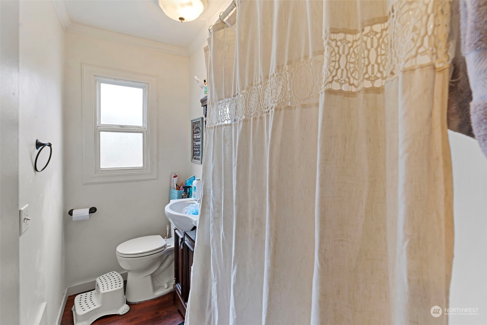 11726 Center Road Everett, WA 98204 - Photo 12 of 34 a white toilet sitting next to a shower curtain