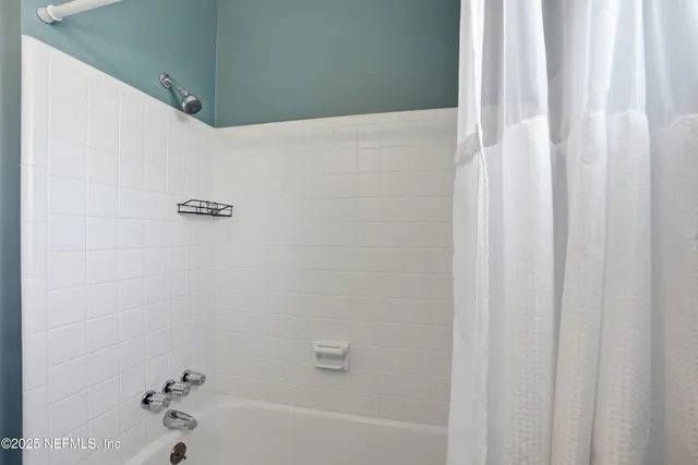 a bathroom with a sink a mirror and a shower