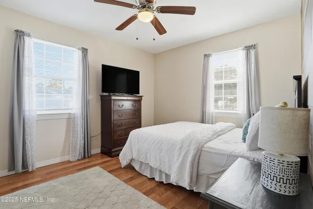 a bedroom with a bed and a flat tv screen