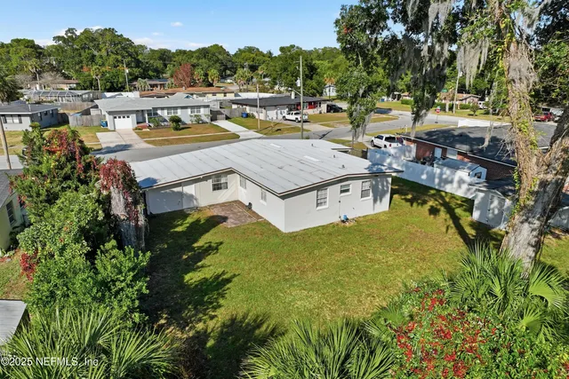 an aerial view of residential houses with outdoor space and swimming pool