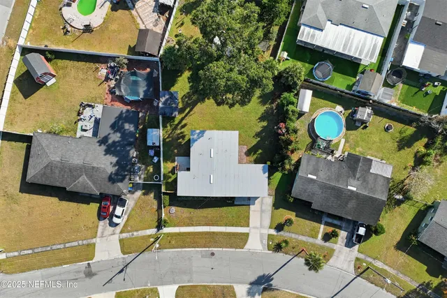 an aerial view of houses with yard