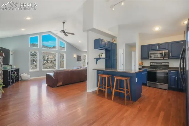 a kitchen with stainless steel appliances granite countertop a refrigerator and a stove top oven