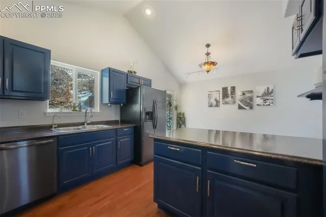 a kitchen with a sink cabinets and chair