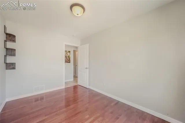 a view of a room with wooden floor