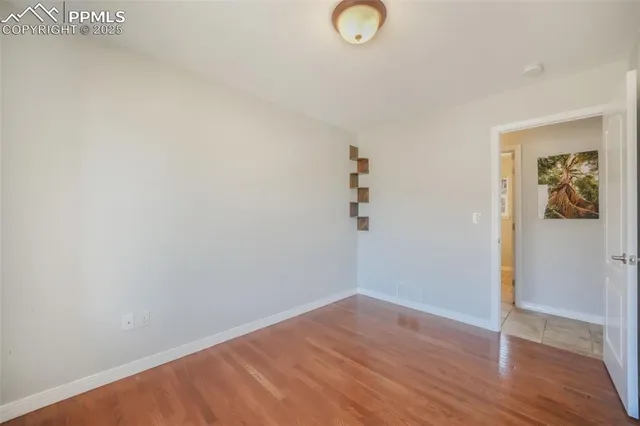 a bathroom with a granite countertop toilet sink and mirror