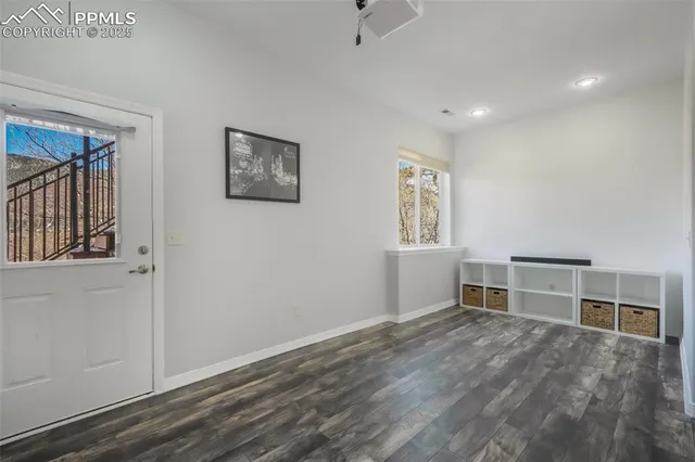 a view of a livingroom with wooden floor and a flat screen tv