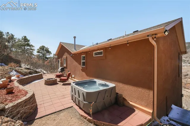 a backyard of a house with table and chairs