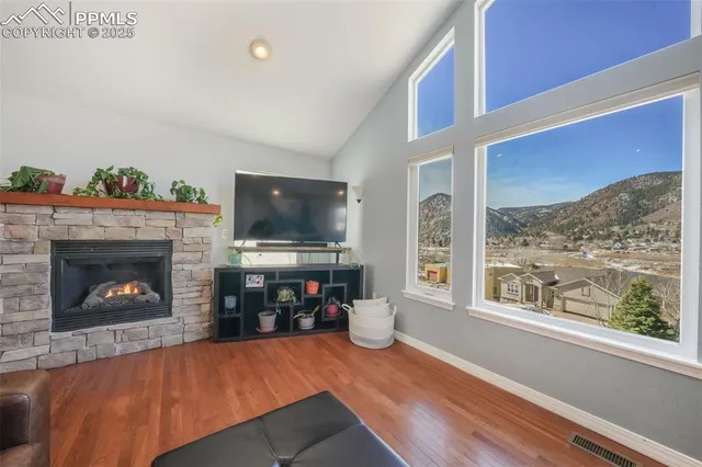 a living room with furniture a fireplace and a flat screen tv