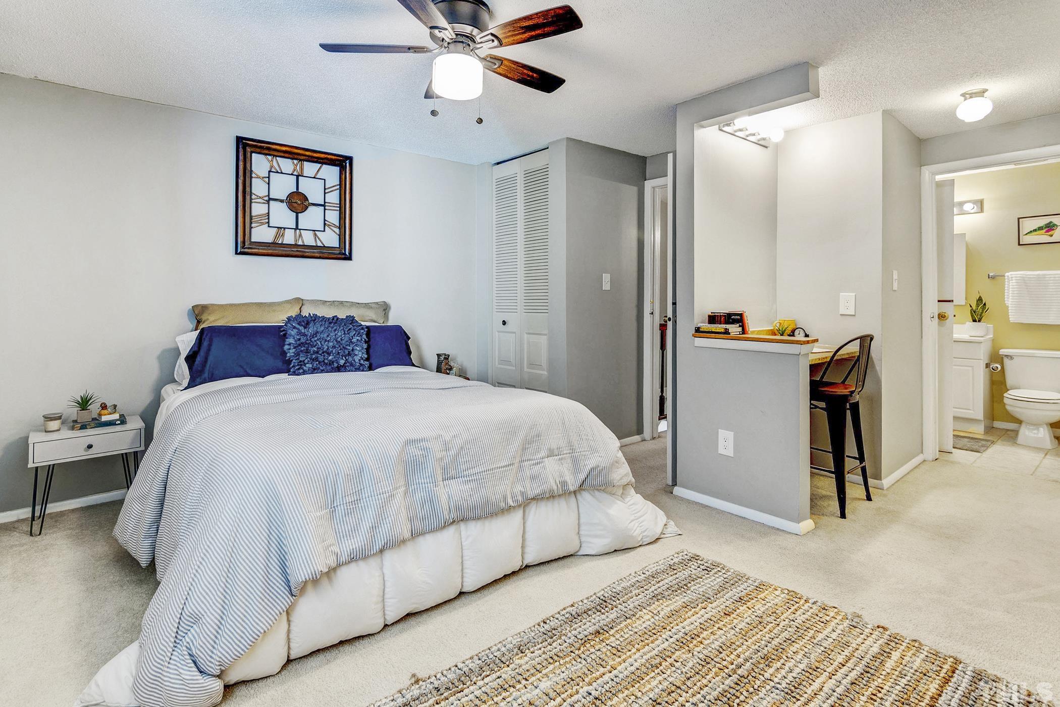 7706 Ohmann Court Raleigh, NC 27615 - Photo 14 of 27 a bedroom with a bed and a chandelier