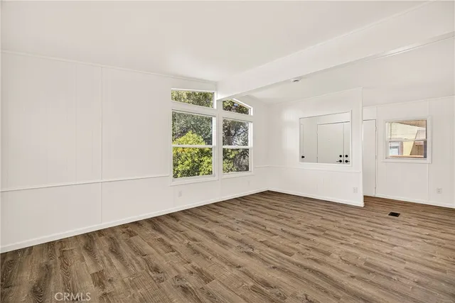 wooden floor in an empty room with a window