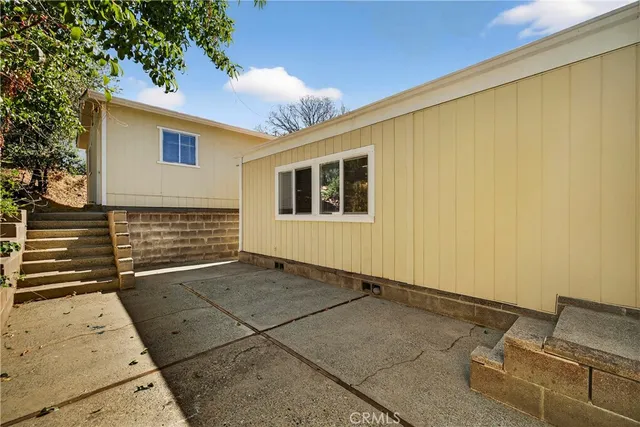an aerial view of a house with a yard and trees