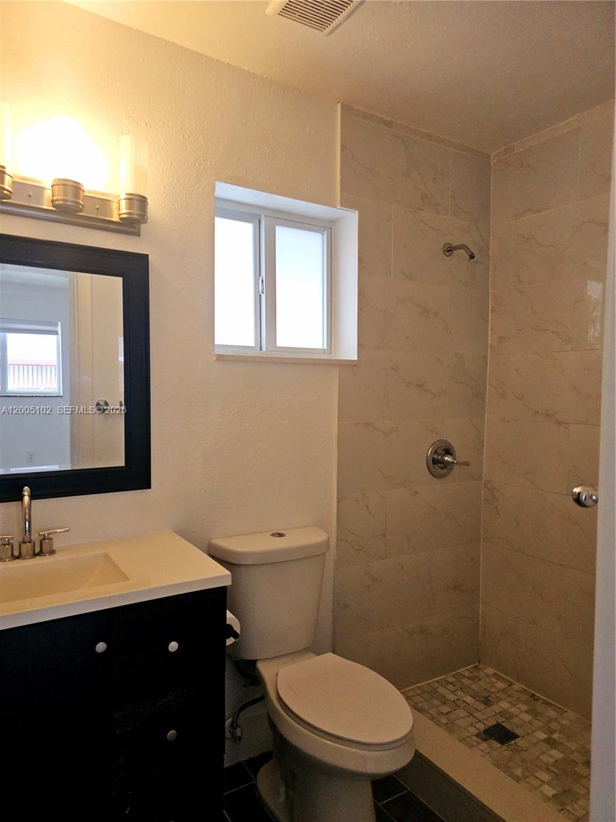 1736 Southwest 3rd Street, Unit 3 Miami, FL 33135 - Photo 4 of 10 a bathroom with a sink a toilet and shower